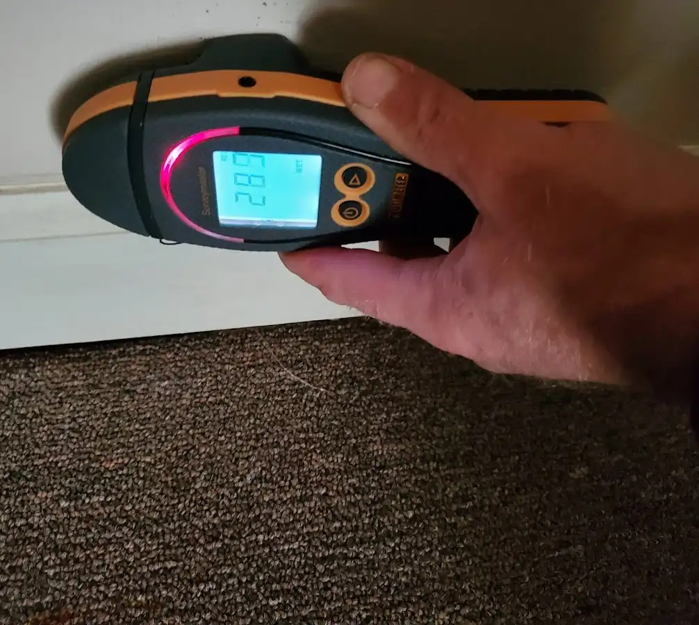 Moisture detection at baseboard during Storm Damage Restoration in Trinity